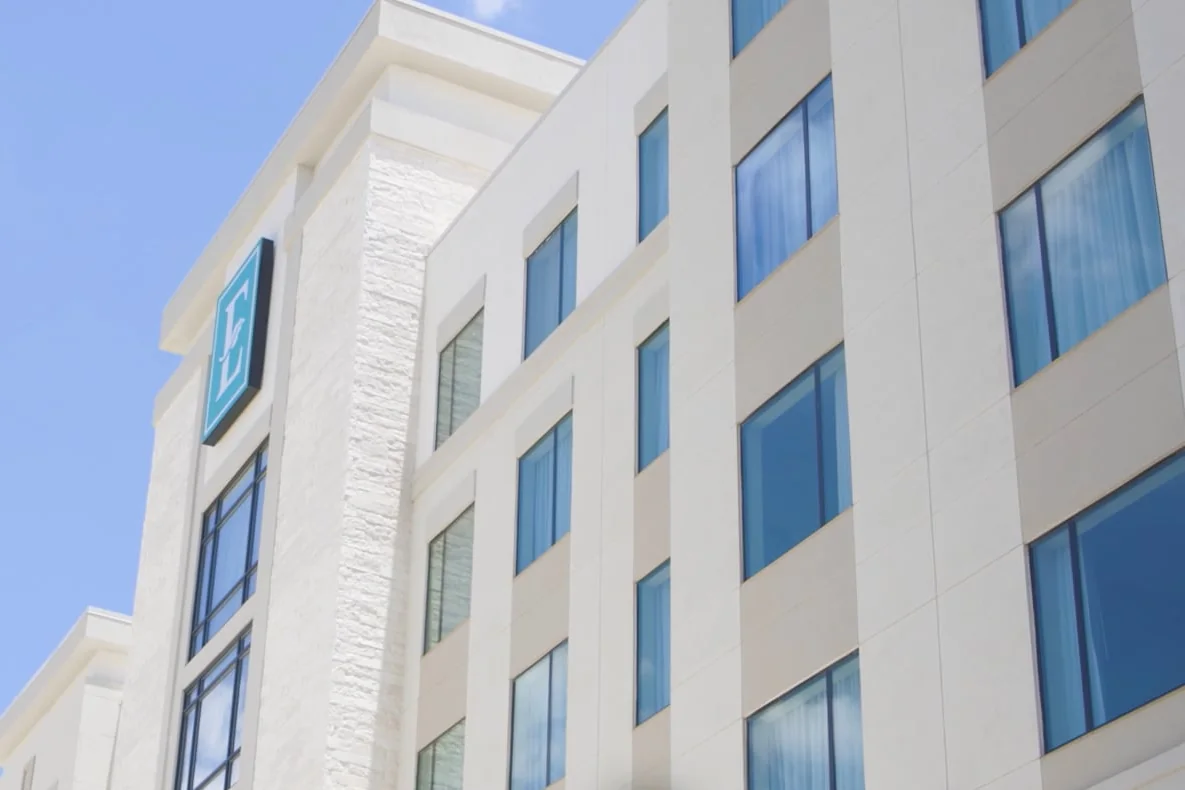 Embassy Suites by Hilton Round Rock tower and its E sign against a blue sky